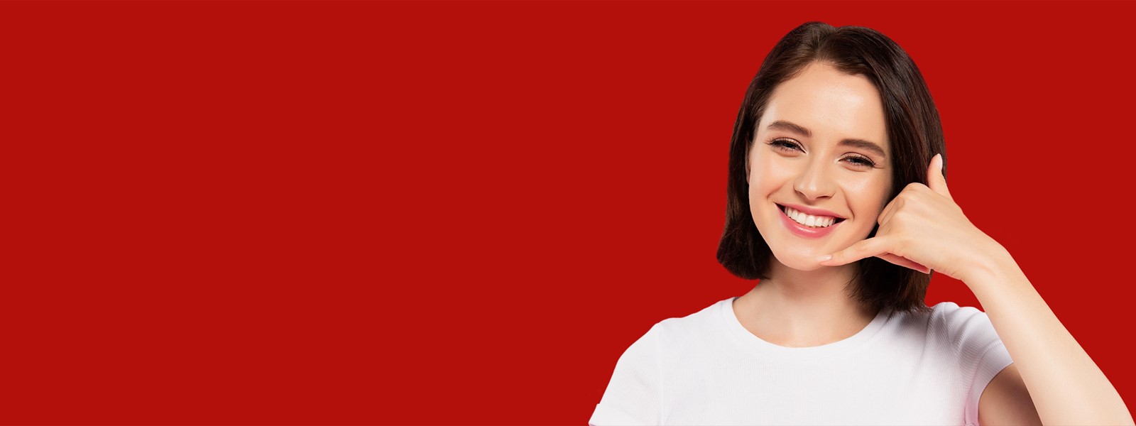 Header photo of a woman smiling making a phone gesture and a red background